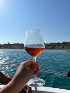 a person holding a glass of beer on a boat at Casa Basilico' Taormina in Taormina +21 photos