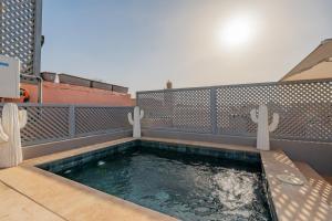 a small pool of water with two cactuses in it at Riad SWAN-exclusif - Piscine chauffée - Petit déjeuner in Marrakech