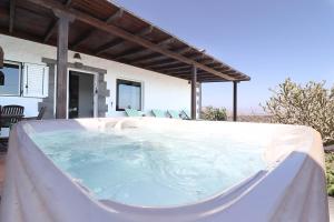 a hot tub on the patio of a house at Casa Aloe in Teseguite +4 photos