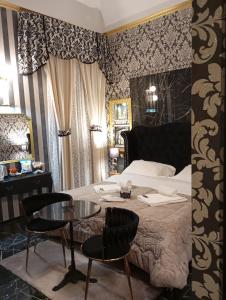 a bedroom with a bed and a table and chairs at Barberini Dream in Rome