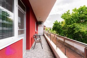 a balcony with a chair and a window at Апартамент Веирас 2 in Velingrad +2 photos