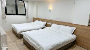 Postel nebo postele na pokoji v ubytování Fulong City B&B