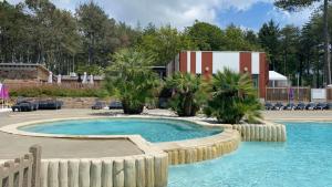 a large swimming pool with a fence around it at MysavinaHouse mobilhome 4 à 6 pers camping 4 Etoiles in Piriac-sur-Mer