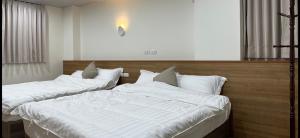Postel nebo postele na pokoji v ubytování Fulong City B&B