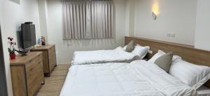 Postel nebo postele na pokoji v ubytování Fulong City B&B