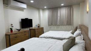 Postel nebo postele na pokoji v ubytování Fulong City B&B