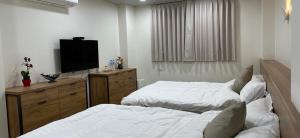 Postel nebo postele na pokoji v ubytování Fulong City B&B