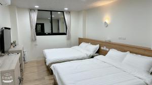 Postel nebo postele na pokoji v ubytování Fulong City B&B