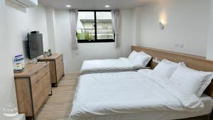 Postel nebo postele na pokoji v ubytování Fulong City B&B