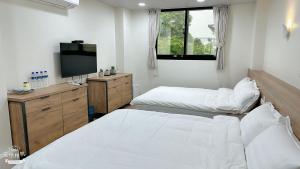 Postel nebo postele na pokoji v ubytování Fulong City B&B