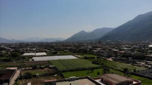 an aerial view of a city with mountains in the background at Freedom in SantʼAntonio Abate