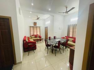 a living room with a table and chairs and a couch at The Falls at Mangal Caverns in Vagamon