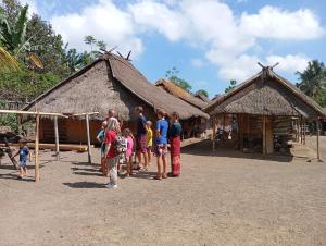 a group of people standing in front of a building at Rumah Kawan Homestay and Trekking in Senaru