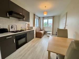a kitchen and living room with a table and a dining room at Domaine des 5 Roses - Rose Blanche in Vendrennes
