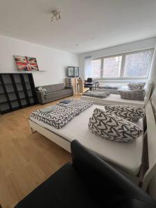 2 große Betten in einem Zimmer mit Sofa in der Unterkunft Big Apartments in Dortmund