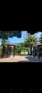 two pictures of a park with a pavilion and a tree at 1br condo 25mins to NAIA SMDC South - 323T2 in Manila