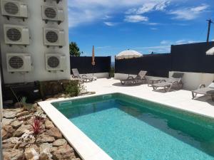 a swimming pool on a patio next to a building at Casas da Serra - Soeima Housing in Alfândega da Fé