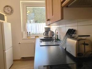 a kitchen with a counter top with a coffee maker at FeWo Bergblick - Oberwiesenthal in Kurort Oberwiesenthal +21 photos
