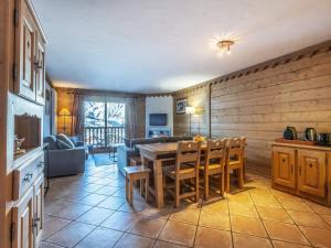 a kitchen and living room with a table and chairs at Appartement cosy avec piscines et spa, pied de pistes, 8 pers, cheminée, parking, animaux admis - FR-1-461-19 in Saint-Martin-de-Belleville