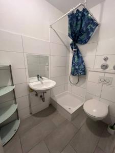 ein weißes Badezimmer mit Waschbecken und Toilette in der Unterkunft Big Apartments in Dortmund + 27 Fotos