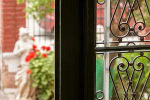 a view of a window with a statue of a woman at Nafsimedon Hotel in Nafplio