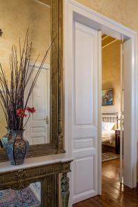 a mirror and a vase on a table in a room at Nafsimedon Hotel in Nafplio