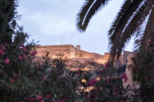a view of a castle with flowers in front of it at Nafsimedon Hotel in Nafplio