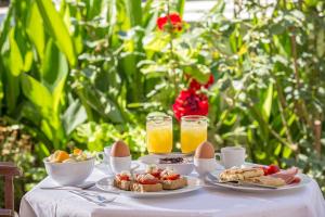 a table topped with plates of food and drinks at Nafsimedon Hotel in Nafplio