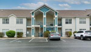 a building with a car parked in a parking lot at Daydreamer - Beautiful Views & Location in Branson