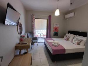 a bedroom with a bed and a living room at Nini's House Superior Nydri - 100m from beach NYDRI TOWN CENTER in Nydri