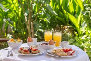 a table with two plates of food and two glasses of orange juice at Nafsimedon Hotel in Nafplio