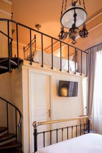 a bedroom with two bunk beds and a staircase at Nafsimedon Hotel in Nafplio