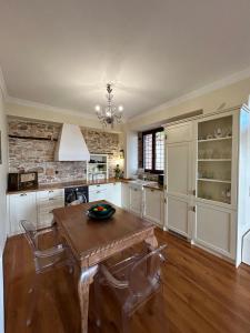 a large kitchen with a wooden table and chairs at Αρχοντικό Νόνη in Mileai