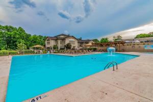 a large swimming pool with blue water at Sweet Clover - Indoor pool - Hot Tub in Branson