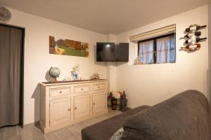 a bedroom with a bed and a tv on the wall at Casa Pina B&B in Spoltore