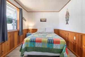 a bedroom with a bed with a colorful quilt at Artilla Cove Cabin 4 - Lake views - Outdoor pool in Branson