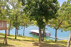 a dock with a boat on a lake at Artilla Cove Cabin 4 - Lake views - Outdoor pool in Branson