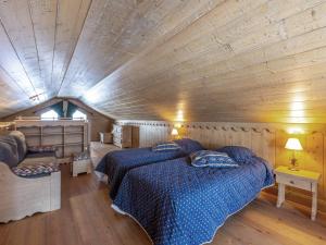 a bedroom with two beds and a wooden ceiling at Grand appartement de 10 pers. avec piscine, spa et parking à Saint-Martin-de-Belleville - FR-1-461-7 in Saint-Martin-de-Belleville +19 photos