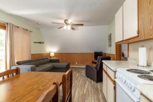 a kitchen and living room with a table and a couch at Artilla Cove Cabin 10- Lake views- Pool & Hot Tub in Branson