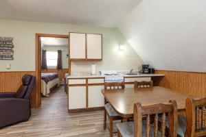 a kitchen and dining room with a table and chairs at Artilla Cove Cabin 10- Lake views- Pool & Hot Tub in Branson +24 photos