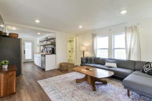 a living room with a couch and a table at Laketown Cottages Blue Anchor in Rockaway Beach