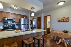 a kitchen with a counter top and a table at Divine 9 Condo -Fishing Lake & Hiking Trails in Reeds Spring