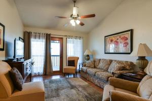 a living room with a couch and a ceiling fan at Divine 9 Condo -Fishing Lake & Hiking Trails in Reeds Spring