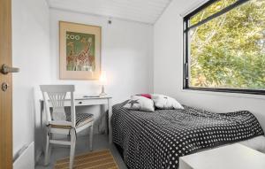 a bedroom with a bed and a desk and a window at 3 Bedroom Lovely Home In Eskebjerg in Eskebjerg