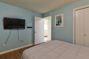 a bedroom with a bed and a flat screen tv on the wall at Mountain Getaway- Outdoor Pool Hiking Trails in Reeds Spring