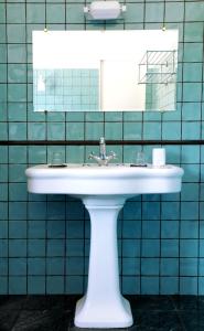 a bathroom with a white sink and a mirror at Hotel Ermitage in Saint-Tropez +20 photos