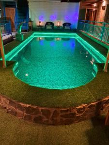 a swimming pool with blue lights in a building at Hostal Illauca de Atacama in San Pedro de Atacama