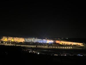 a large building with lights on it at night at Gabry Grand Egyptian Museum and Pyramids Hotel in Cairo