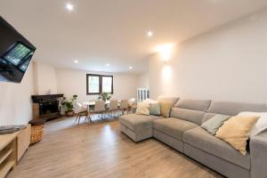 a living room with a couch and a table at Alentejo Villa Nordic Spa & Pool in Santo António do Alcôrrego