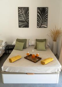 a bed with a tray of drinks on it at Casa Rural La Yesería Alcocer in Sacedón